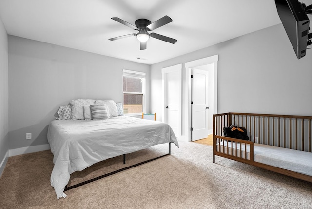 carpeted bedroom featuring baseboards and ceiling fan