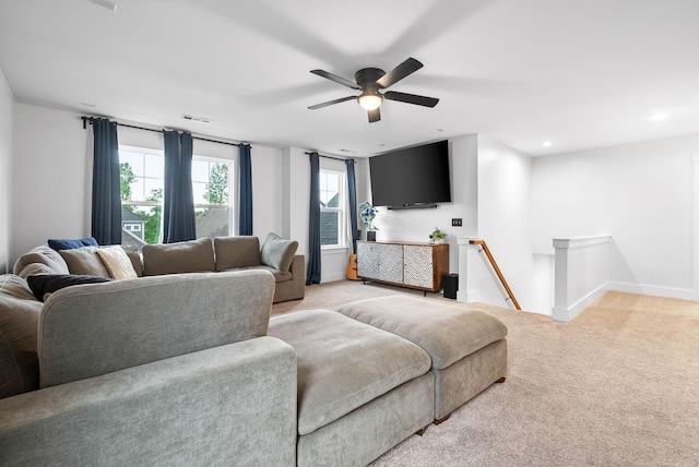 living room featuring light colored carpet, ceiling fan, baseboards, and recessed lighting