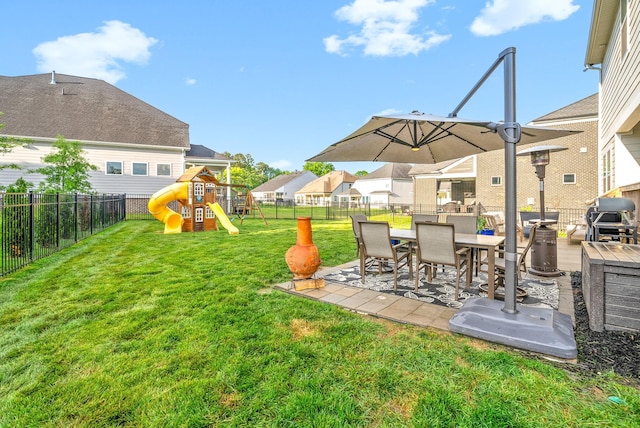 view of yard with a playground, a patio area, and outdoor dining space