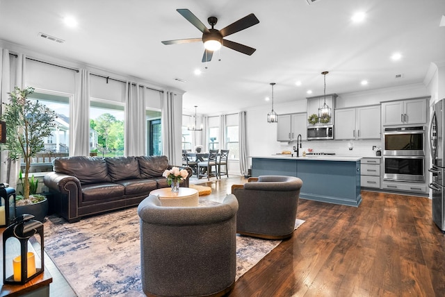 living area featuring a ceiling fan, dark wood-style floors, recessed lighting, and ornamental molding