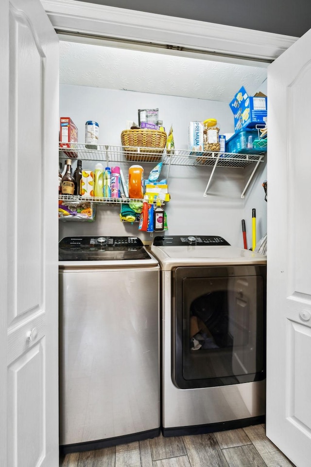 washroom with washer and dryer and light wood-style flooring