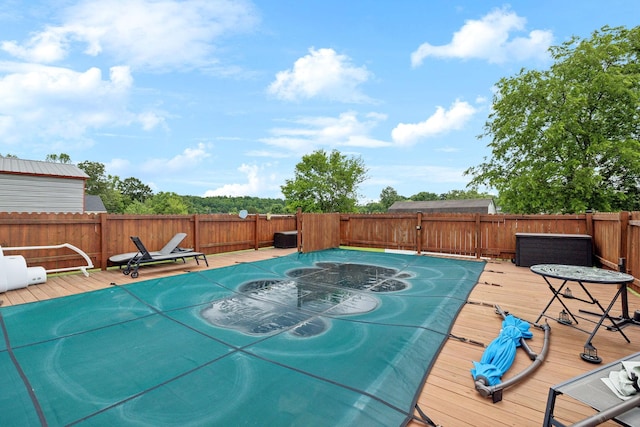 view of swimming pool with a fenced backyard and a wooden deck