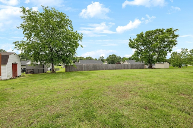 view of yard featuring a storage unit and an outbuilding