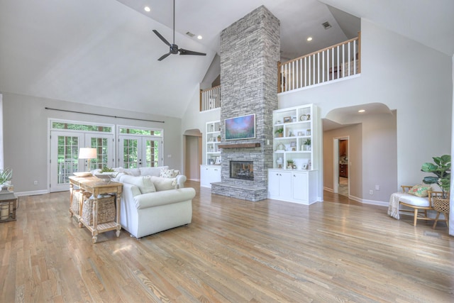 114 Moonlight Dr, Gallatin, TN 37066 - living room with high vaulted ceiling, ceiling fan, baseboards, wood finished floors, and a stone fireplace