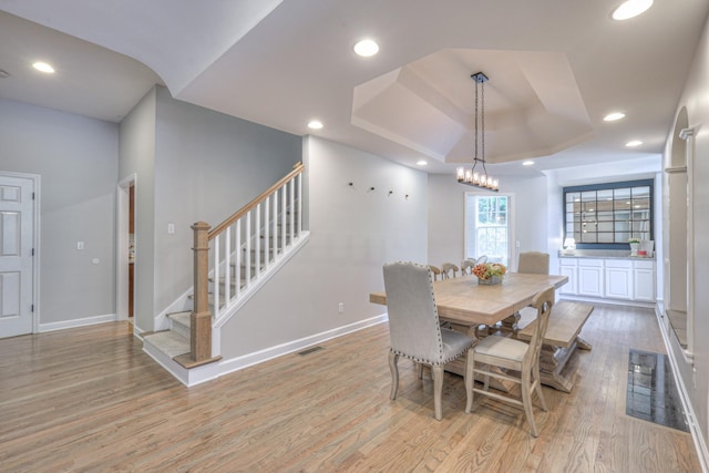 114 Moonlight Dr, Gallatin, TN 37066 - dining room featuring light wood-style floors, a raised ceiling, stairway, baseboards, and recessed lighting