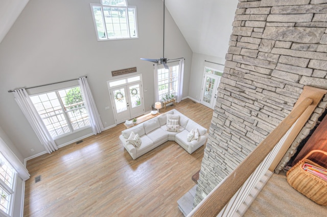 114 Moonlight Dr, Gallatin, TN 37066 - living room featuring high vaulted ceiling, wood finished floors, healthy amount of natural light, and baseboards