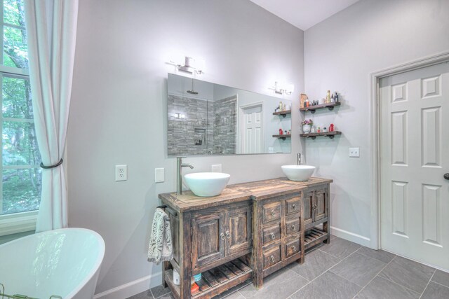 114 Moonlight Dr, Gallatin, TN 37066 - full bathroom featuring a freestanding tub, baseboards, tiled shower, and double vanity