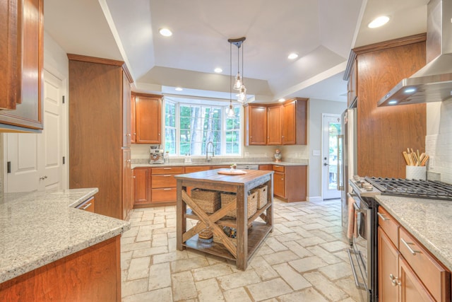 114 Moonlight Dr, Gallatin, TN 37066 - kitchen with gas range, wall chimney exhaust hood, decorative backsplash, light stone counters, and a sink