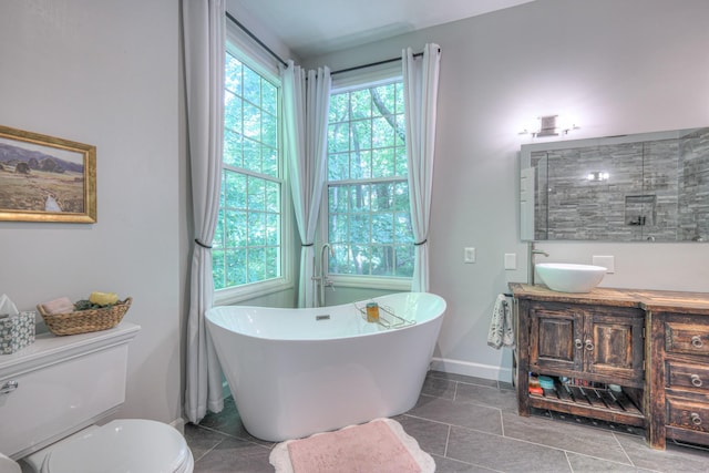114 Moonlight Dr, Gallatin, TN 37066 - bathroom with vanity, a freestanding bath, toilet, and baseboards