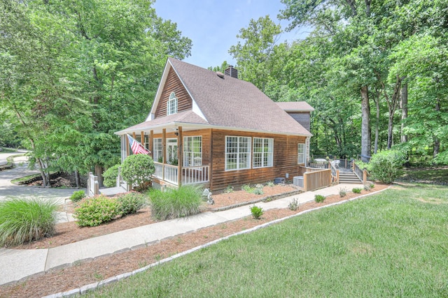 114 Moonlight Dr, Gallatin, TN 37066 - view of front of house with a porch, a shingled roof, a chimney, and a front lawn