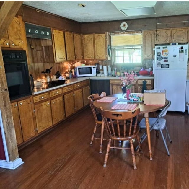 622 Beech St, Centerville, TN 37033 - kitchen with white appliances, brown cabinetry, dark wood-style floors, and light countertops