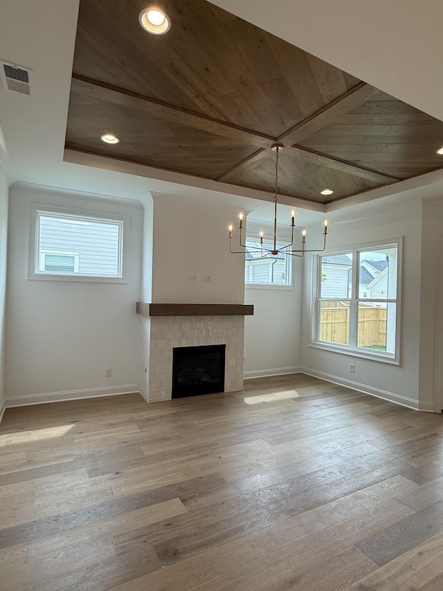 3150 Long Branch Cir, Franklin, TN 37064 - unfurnished living room featuring baseboards, wooden ceiling, a chandelier, hardwood / wood-style flooring, and a tile fireplace