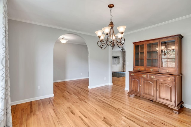1760 Camp Branch Rd, Mount Pleasant, TN 38474 - unfurnished dining area with arched walkways, a chandelier, light wood finished floors, ornamental molding, and baseboards