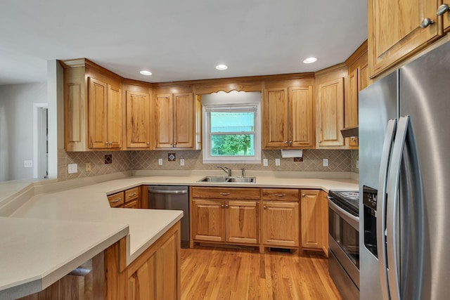 1760 Camp Branch Rd, Mount Pleasant, TN 38474 - kitchen with appliances with stainless steel finishes, a sink, light wood-style flooring, light countertops, and tasteful backsplash
