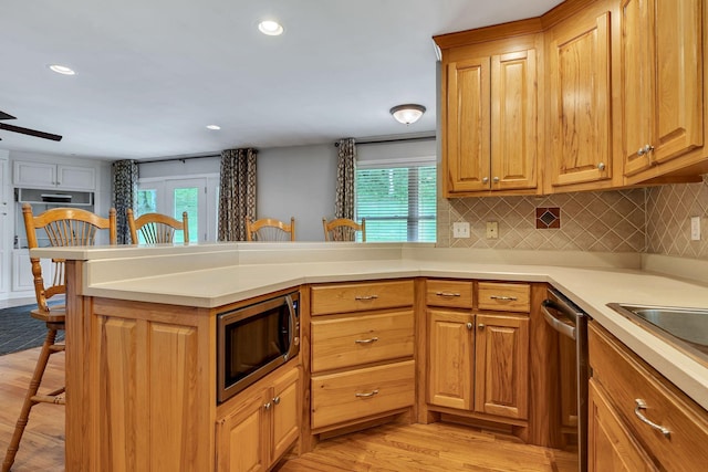1760 Camp Branch Rd, Mount Pleasant, TN 38474 - kitchen featuring appliances with stainless steel finishes, a breakfast bar area, healthy amount of natural light, light wood-type flooring, and recessed lighting