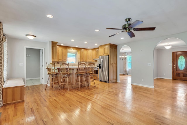 1760 Camp Branch Rd, Mount Pleasant, TN 38474 - kitchen featuring appliances with stainless steel finishes, a kitchen breakfast bar, a ceiling fan, a peninsula, and arched walkways
