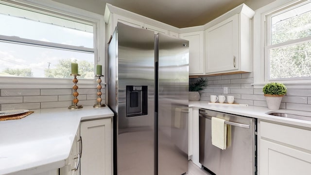 1304 Cheshire Dr, Nashville, TN 37207 - kitchen with stainless steel appliances, backsplash, white cabinets, light countertops, and a sink