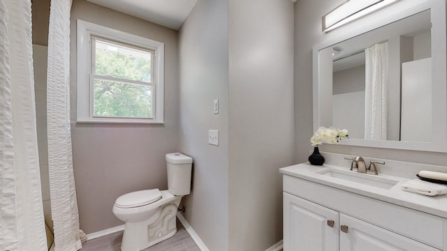 1304 Cheshire Dr, Nashville, TN 37207 - bathroom featuring toilet, vanity, wood finished floors, and baseboards