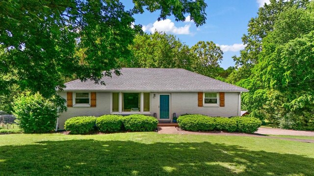 1304 Cheshire Dr, Nashville, TN 37207 - view of front of house with a front yard, brick siding, and roof with shingles