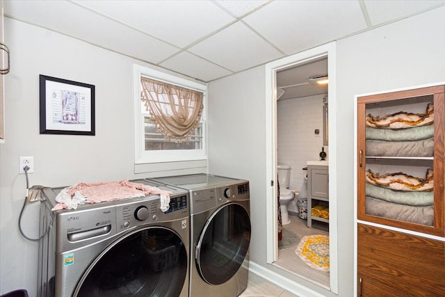 1304 Cheshire Dr, Nashville, TN 37207 - clothes washing area with washing machine and dryer and tile patterned floors