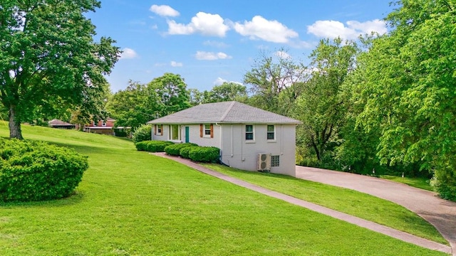 1304 Cheshire Dr, Nashville, TN 37207 - rear view of house featuring a lawn, driveway, and view of wooded area