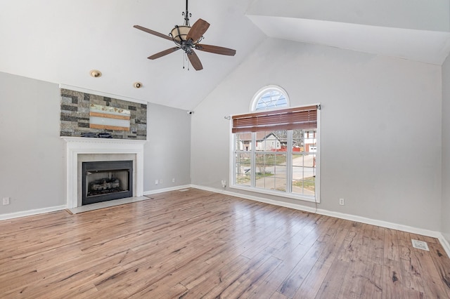807 Sugarcane Way, Clarksville, TN 37040 - unfurnished living room with high vaulted ceiling, wood finished floors, ceiling fan, a large fireplace, and baseboards