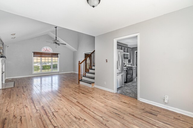 807 Sugarcane Way, Clarksville, TN 37040 - unfurnished living room featuring stairway, light wood-style flooring, a ceiling fan, lofted ceiling, and baseboards