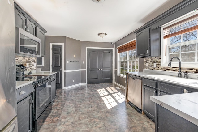 807 Sugarcane Way, Clarksville, TN 37040 - kitchen with appliances with stainless steel finishes, tasteful backsplash, a sink, stone finish flooring, and baseboards