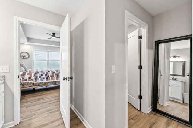 2955 Spring Place Rd, Belfast, TN 37019 - corridor featuring light wood-type flooring, a sink, and baseboards