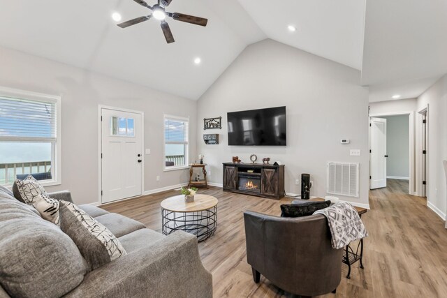 2955 Spring Place Rd, Belfast, TN 37019 - living room with ceiling fan, a warm lit fireplace, high vaulted ceiling, light wood-style floors, and baseboards