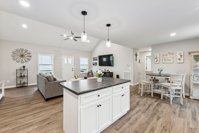 2955 Spring Place Rd, Belfast, TN 37019 - kitchen featuring dark countertops, open floor plan, light wood-type flooring, white cabinetry, and a center island