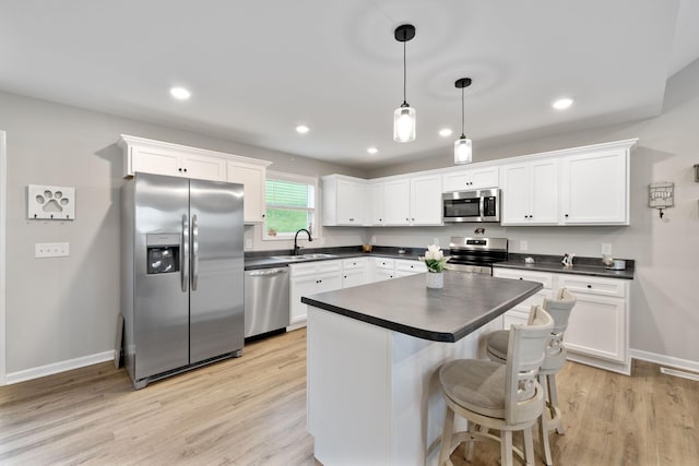 2955 Spring Place Rd, Belfast, TN 37019 - kitchen featuring appliances with stainless steel finishes, dark countertops, a sink, white cabinets, and recessed lighting