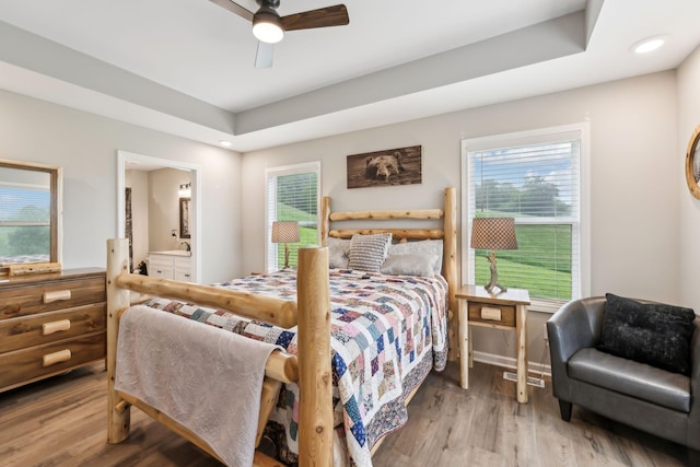 2955 Spring Place Rd, Belfast, TN 37019 - bedroom with wood finished floors, multiple windows, connected bathroom, and ceiling fan