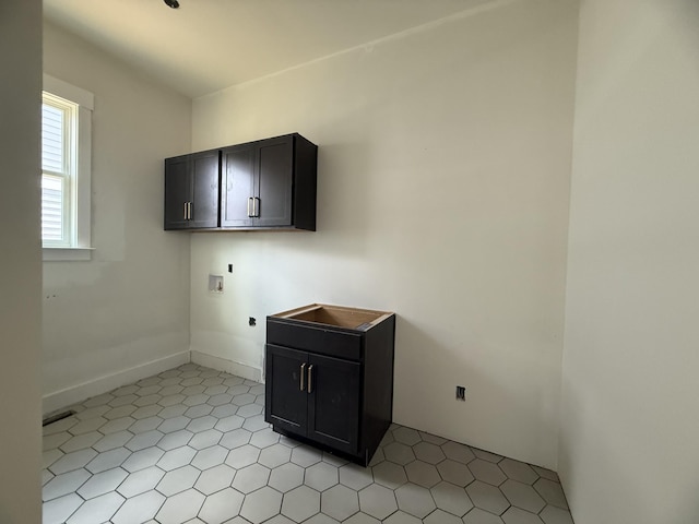7424 Leelee Dr, Franklin, TN 37064 - laundry room featuring hookup for an electric dryer, washer hookup, cabinet space, and light tile patterned floors