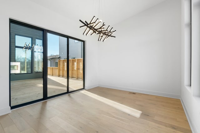 unfurnished room featuring wood finished floors and baseboards