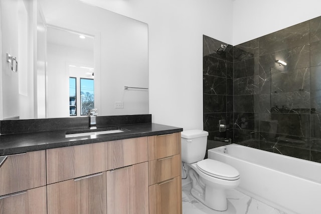bathroom with vanity, toilet, marble look tile flooring, and shower / washtub combination