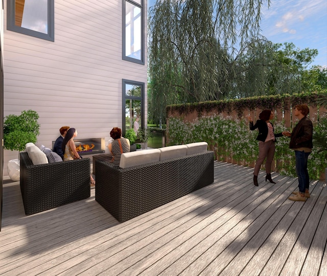 deck with an outdoor living space with a fire pit