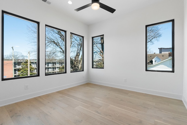 unfurnished room featuring plenty of natural light, light wood finished floors, ceiling fan, baseboards, and recessed lighting