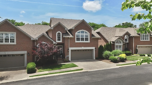 1005 Peck Pl, Hendersonville, TN 37075 - traditional home featuring driveway, brick siding, an attached garage, and a shingled roof