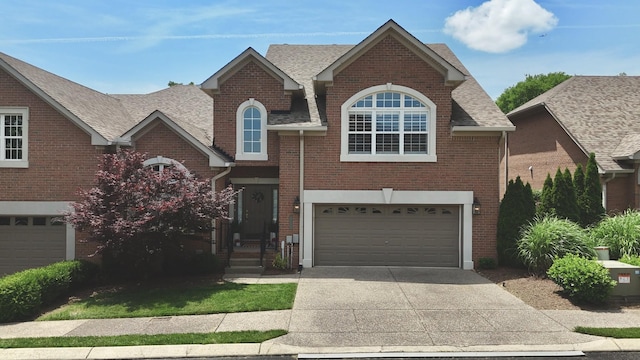1005 Peck Pl, Hendersonville, TN 37075 - traditional-style home featuring driveway, an attached garage, brick siding, and roof with shingles