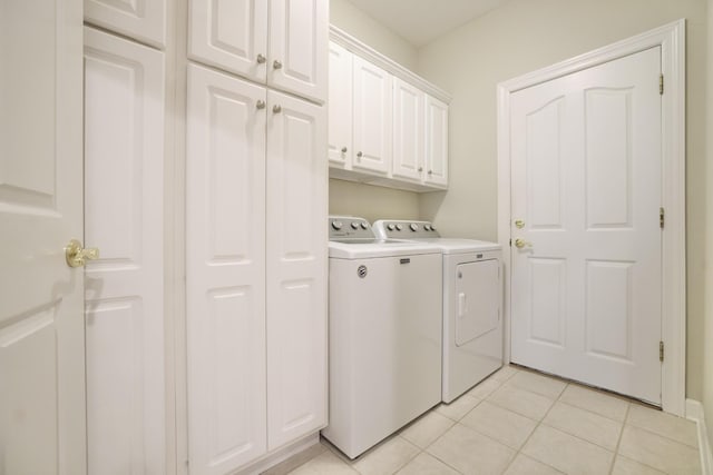 1005 Peck Pl, Hendersonville, TN 37075 - laundry area with washer and dryer, cabinet space, and light tile patterned flooring