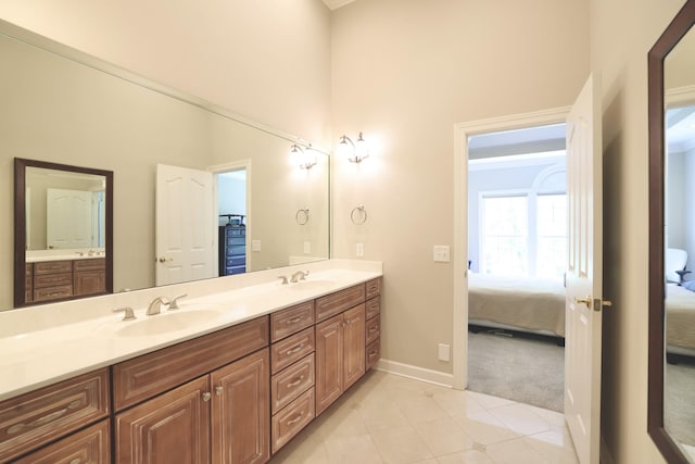 1005 Peck Pl, Hendersonville, TN 37075 - full bathroom featuring ensuite bathroom, double vanity, tile patterned flooring, baseboards, and a towering ceiling
