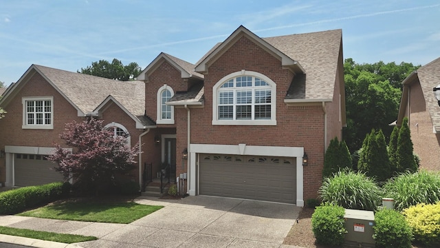 1005 Peck Pl, Hendersonville, TN 37075 - view of front of house with a garage, concrete driveway, brick siding, and a shingled roof