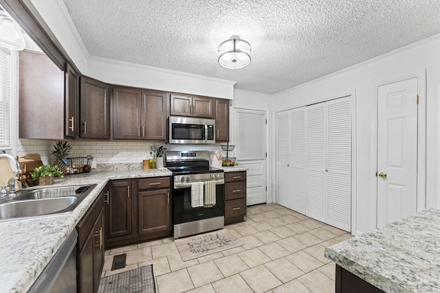 211 Elmwood Dr, Murfreesboro, TN 37128 - kitchen featuring appliances with stainless steel finishes, a sink, dark brown cabinetry, a textured ceiling, and light countertops