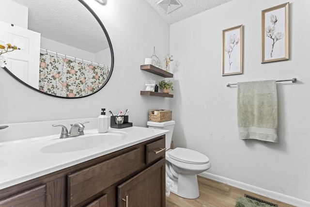 211 Elmwood Dr, Murfreesboro, TN 37128 - full bath with a textured ceiling, toilet, wood finished floors, vanity, and baseboards