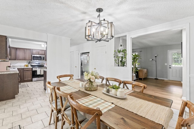 211 Elmwood Dr, Murfreesboro, TN 37128 - dining space featuring a chandelier and a textured ceiling