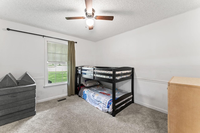 211 Elmwood Dr, Murfreesboro, TN 37128 - carpeted bedroom with a textured ceiling, baseboards, and a ceiling fan