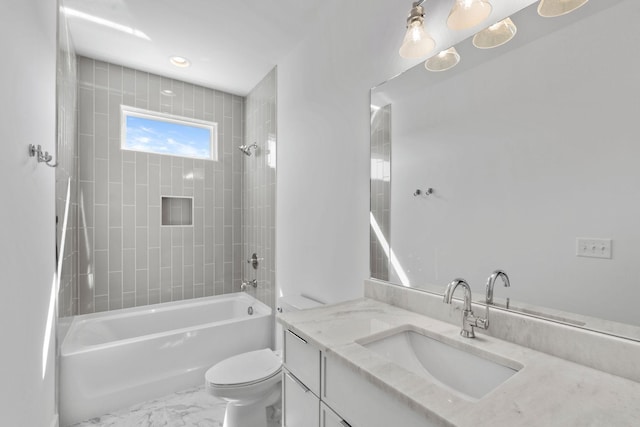 bathroom featuring toilet, vanity, washtub / shower combination, and marble finish floors