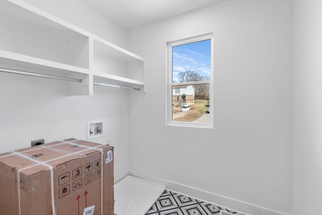 washroom with electric dryer hookup, washer hookup, and baseboards