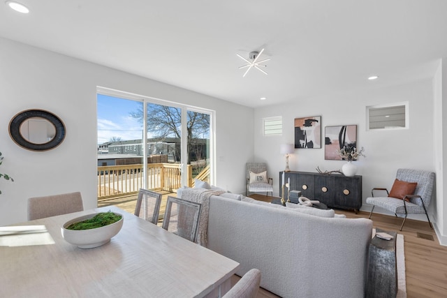 living area featuring wood finished floors and recessed lighting